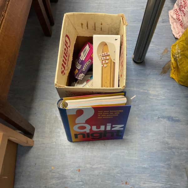 Mixed lot of board games and a quiz book for family entertainment.