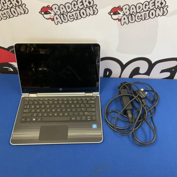 HP Pavilion x360 laptop with touchscreen and charger.