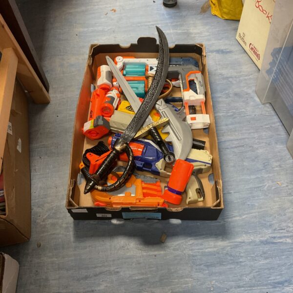 Mixed lot of Nerf guns, X Shot blasters, and plastic swords.