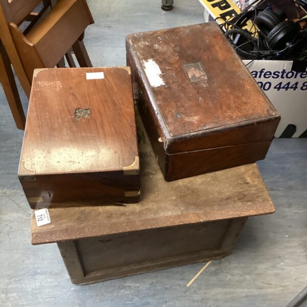 Vintage wooden writing slopes and storage box on a table.