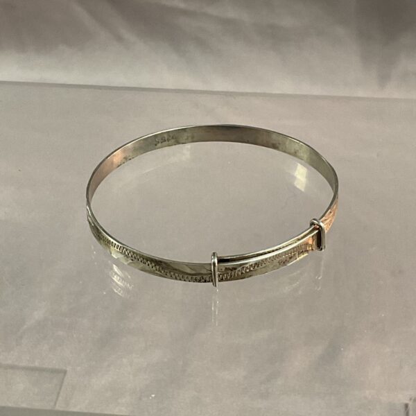 Vintage silver christening bangle, a classic baby gift.
