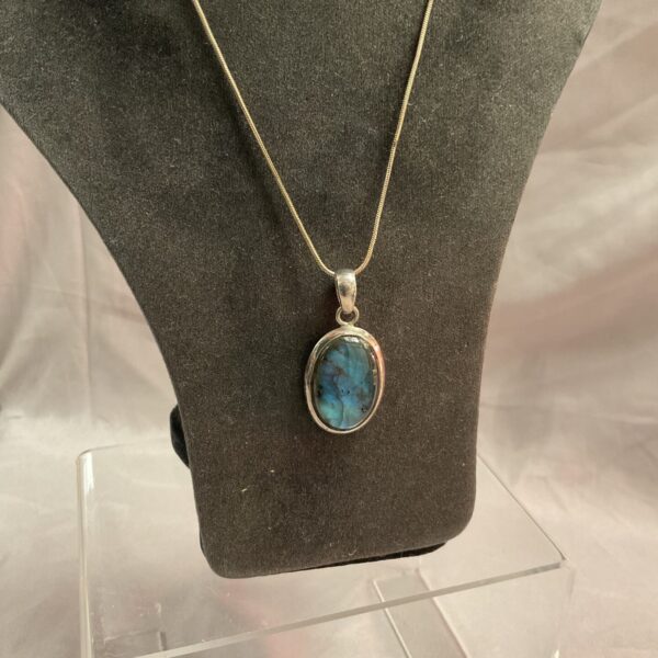 Silver necklace with large labradorite cabochon pendant.
