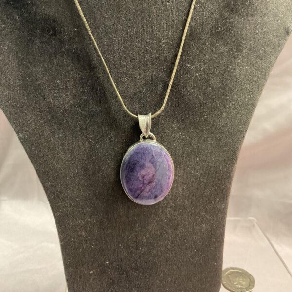 Close-up of a beautiful charoite pendant necklace in sterling silver.