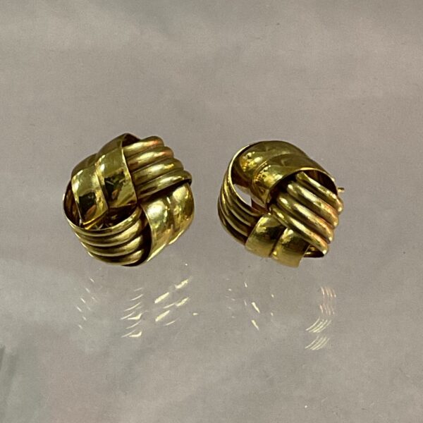 Hallmarked 9ct gold knot earrings with intricate design.
