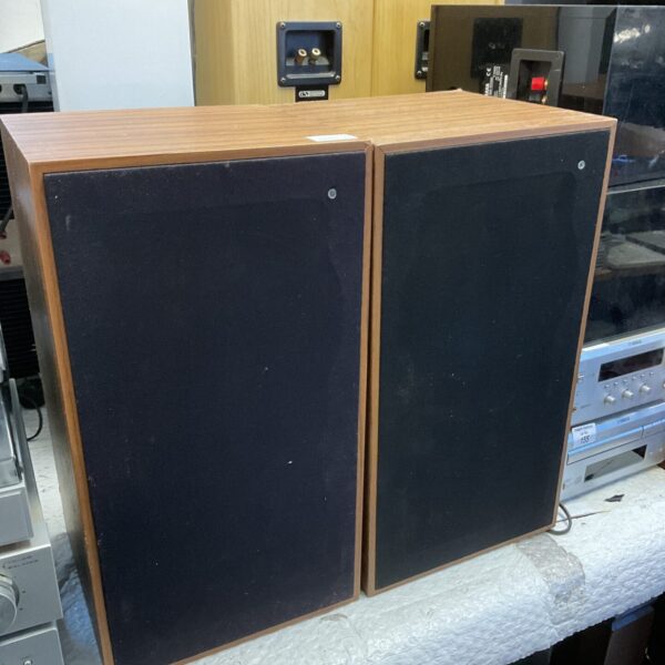 Pair of vintage bookshelf speakers with wooden cabinets.