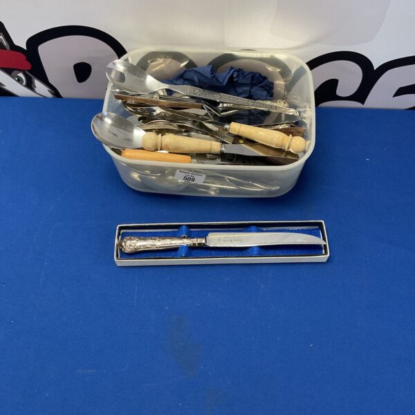 Vintage silver handled cake knife in a mixed cutlery lot.
