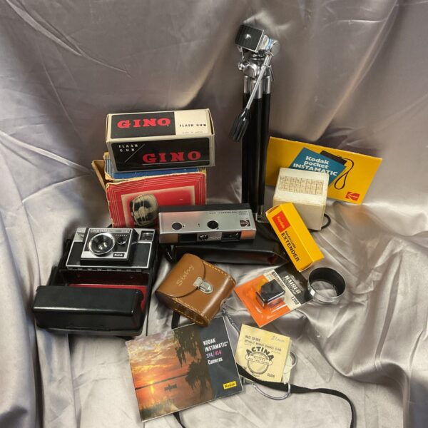 Vintage Kodak camera lot with flash gun and case.