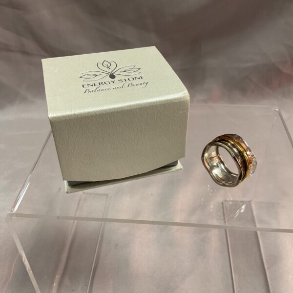 Sterling silver spinner ring with brass and copper details, size U.