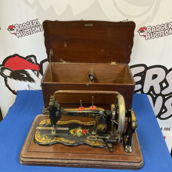 Antique Bradbury & Co sewing machine with ornate detailing.