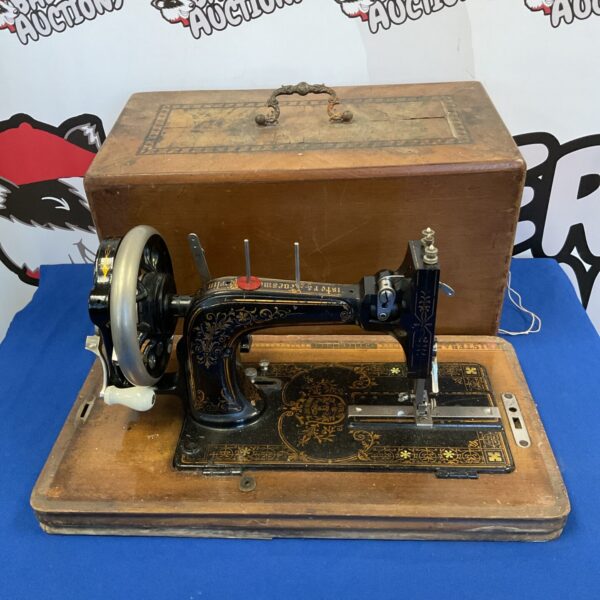Antique Frister & Rossman sewing machine, vintage collectible with ornate details.