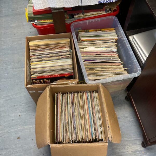 Large boxes filled with a collection of vintage vinyl records, primarily rock music.
