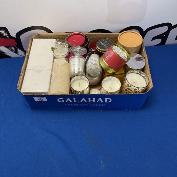 Assorted candles and diffusers in a cardboard box.