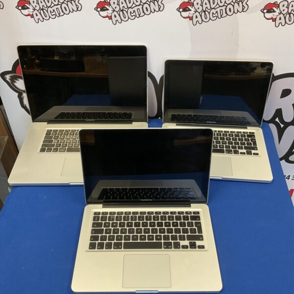 Lot of three Apple Macbook Pro laptops for auction.