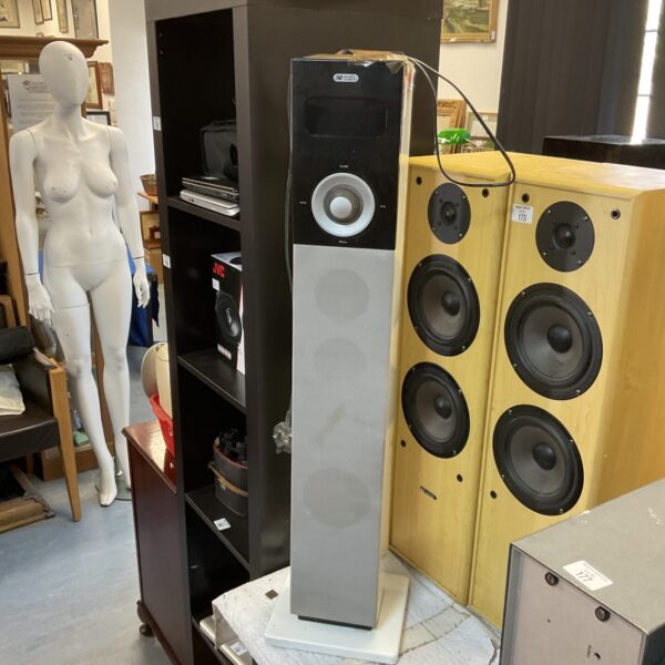 Silver and black Acoustic Solutions tower music system with remote control.