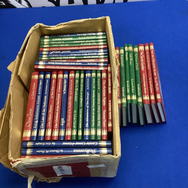 A stack of vintage children's books, including Black Beauty and Oliver Twist.
