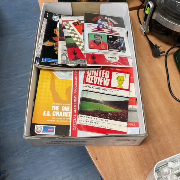 Vintage collection of Manchester United football programs for collectors.
