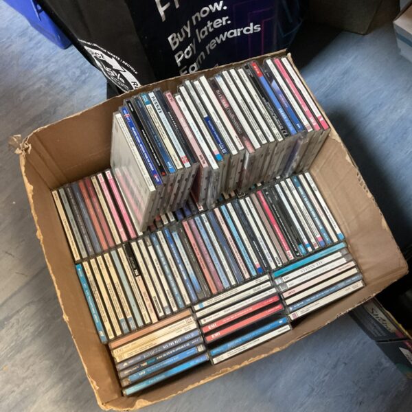 Box of assorted music CDs for collectors and enthusiasts.