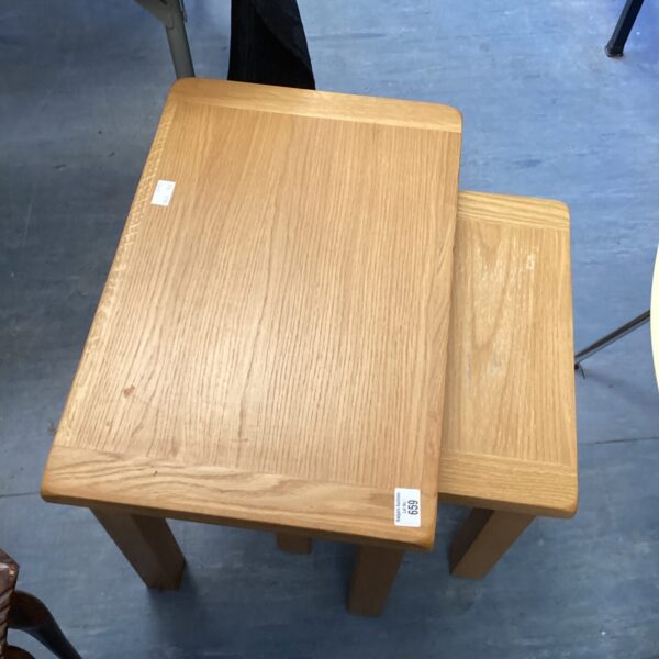 Vintage oak nest of tables in warm natural light.