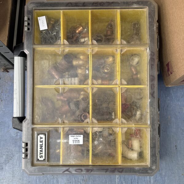 Vintage Stanley compartment box filled with plumbing supplies and tools.