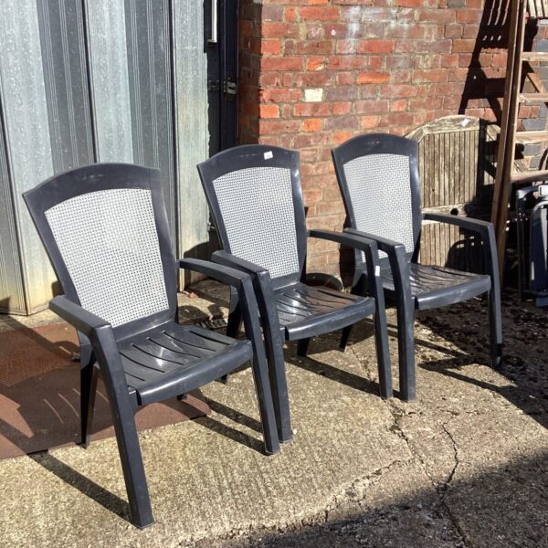 Set of three plastic garden chairs for outdoor use.