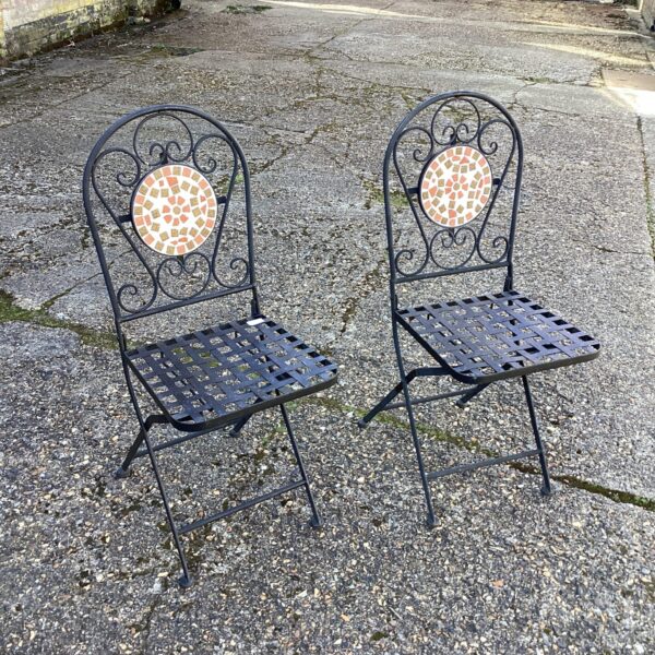 Pair of vintage metal garden chairs with mosaic seats.