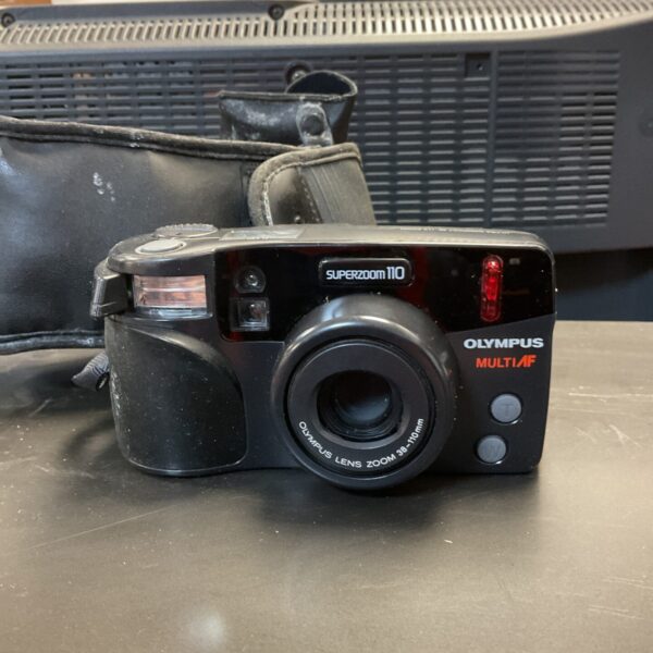 Vintage Olympus Superzoom 110 camera, a compact film camera.