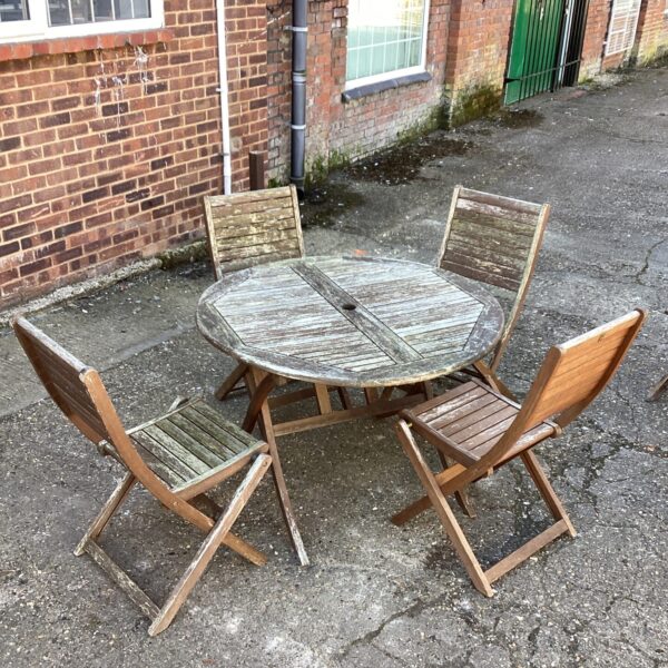 Vintage teak garden furniture set with table and four chairs.