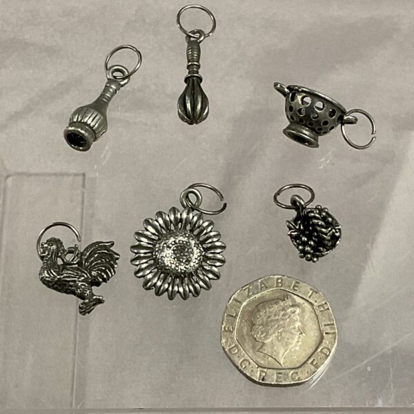Vintage whitemetal charm lot with various designs.