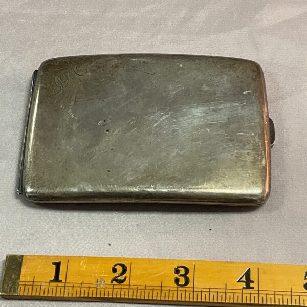 Vintage silver cigarette case with engraved details.