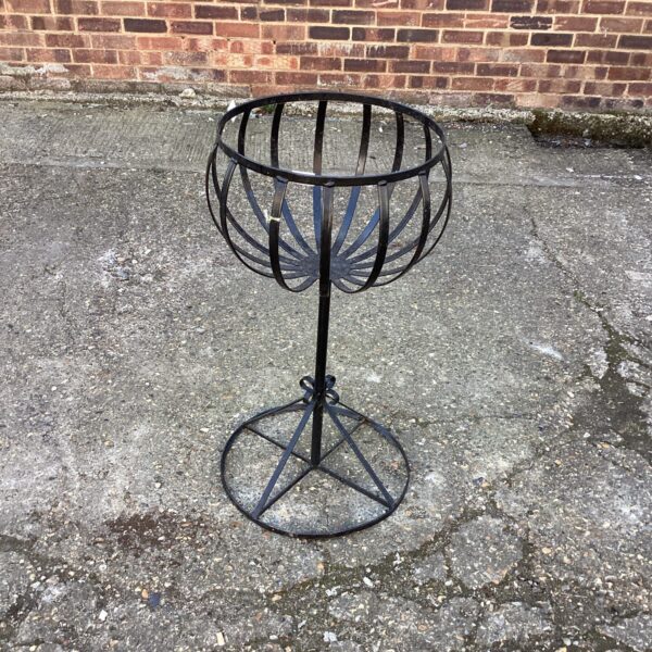 Vintage metal garden planter with tripod base.