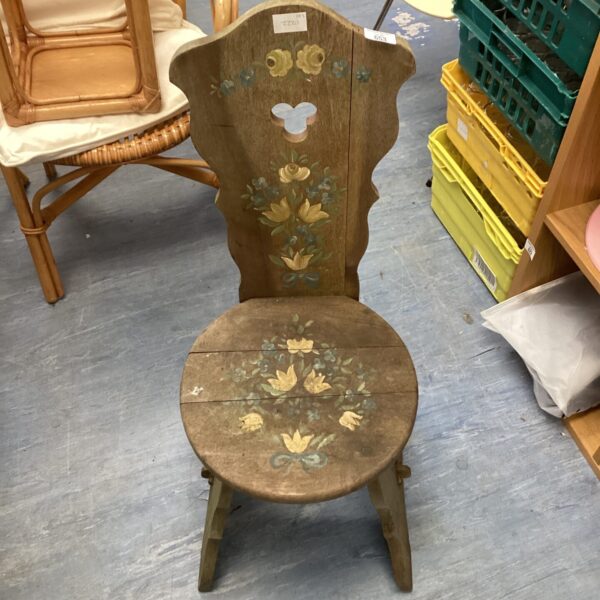 Vintage folk art chair with hand-painted floral design.