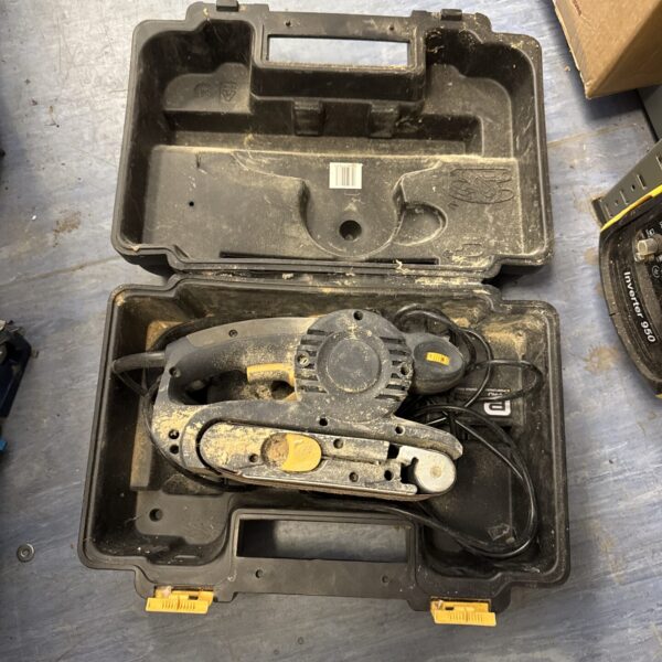 Makita belt sander inside a carrying case, woodworking tool.