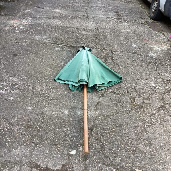 Vintage garden parasol providing outdoor shade in a garden setting.