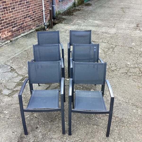 Six metal-framed garden chairs for outdoor use.