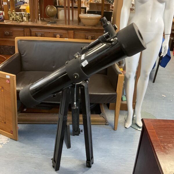 Vintage Tasco telescope on tripod, ideal for astronomical viewing.