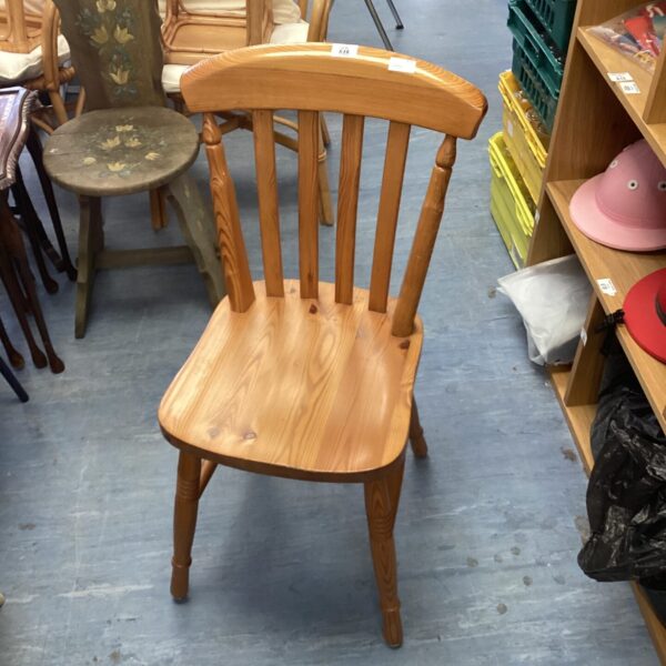 Vintage pine kitchen chair with a curved back.