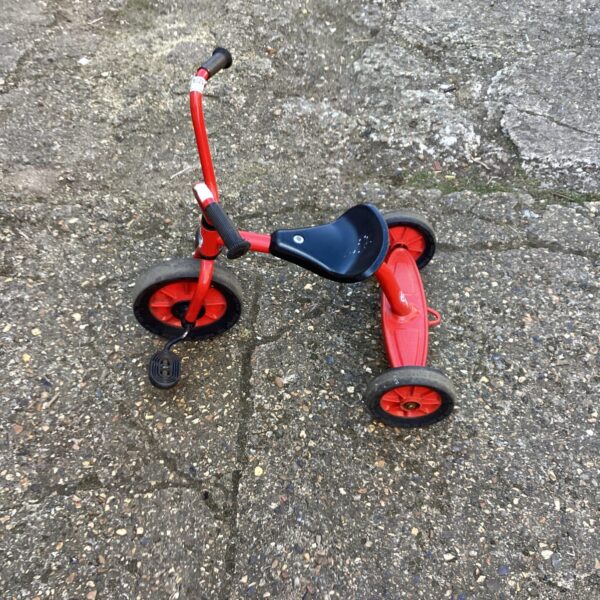 Red vintage Winther tricycle, classic children's toy.