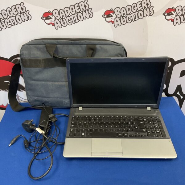 Used Samsung np355v5c laptop with charger, side view.