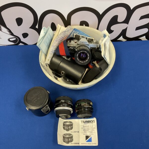 Vintage Canon AV-1 camera with lenses and accessories for film photography.