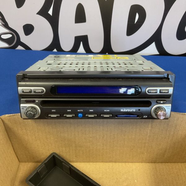 Front view of a vintage Navsure car stereo in used condition.
