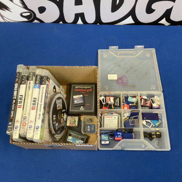 PS3 games and SD card tray lot for gaming and data storage.