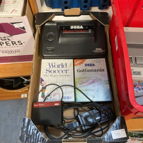 Sega Master System console with games, a retro gaming system.