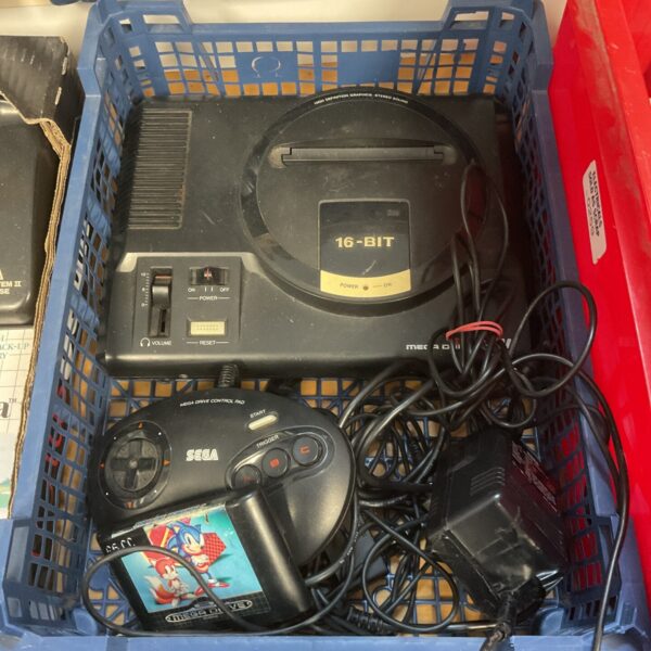 Sega Megadrive console with controller and game for retro gaming.
