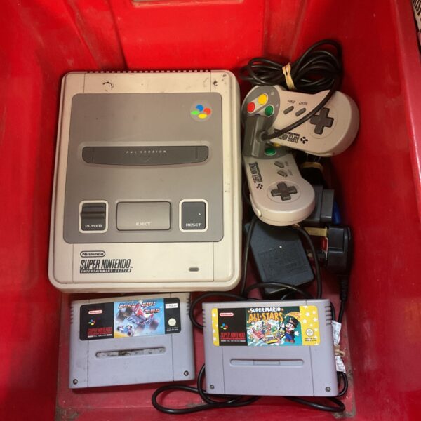 Vintage Super Nintendo SNES console with controllers and game.