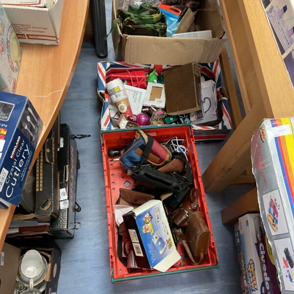 Mixed lot assortment with beauty products, cameras, and assorted items.