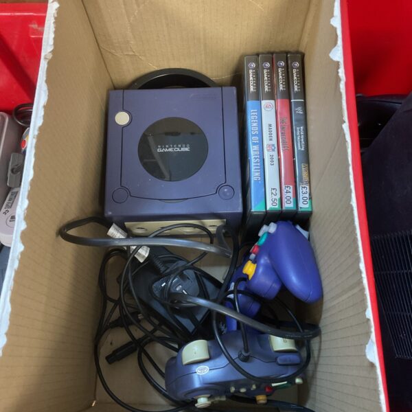 Nintendo GameCube console with controllers and games for retro gaming.
