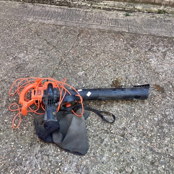 Used Black and Decker lawn vac with collection bag for garden cleaning.