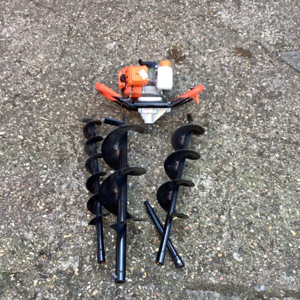 Petrol auger with multiple attachments for garden and landscaping tasks.