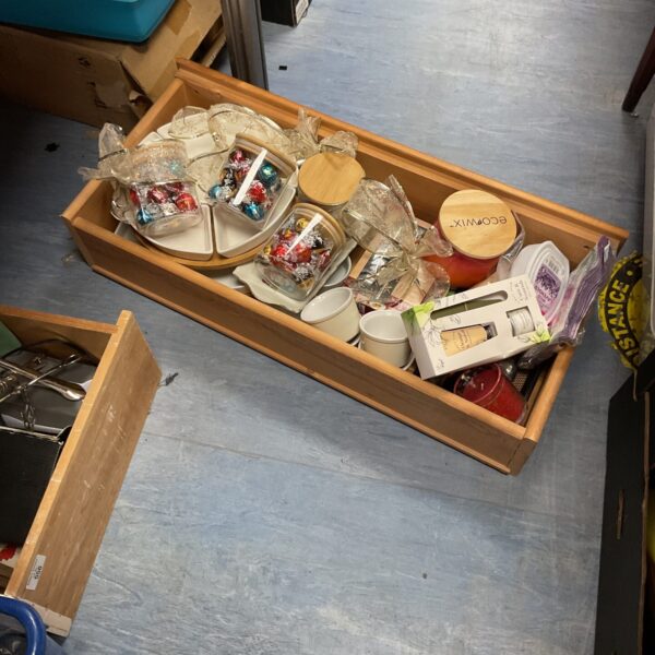 Mixed lot of household items in a wooden drawer.