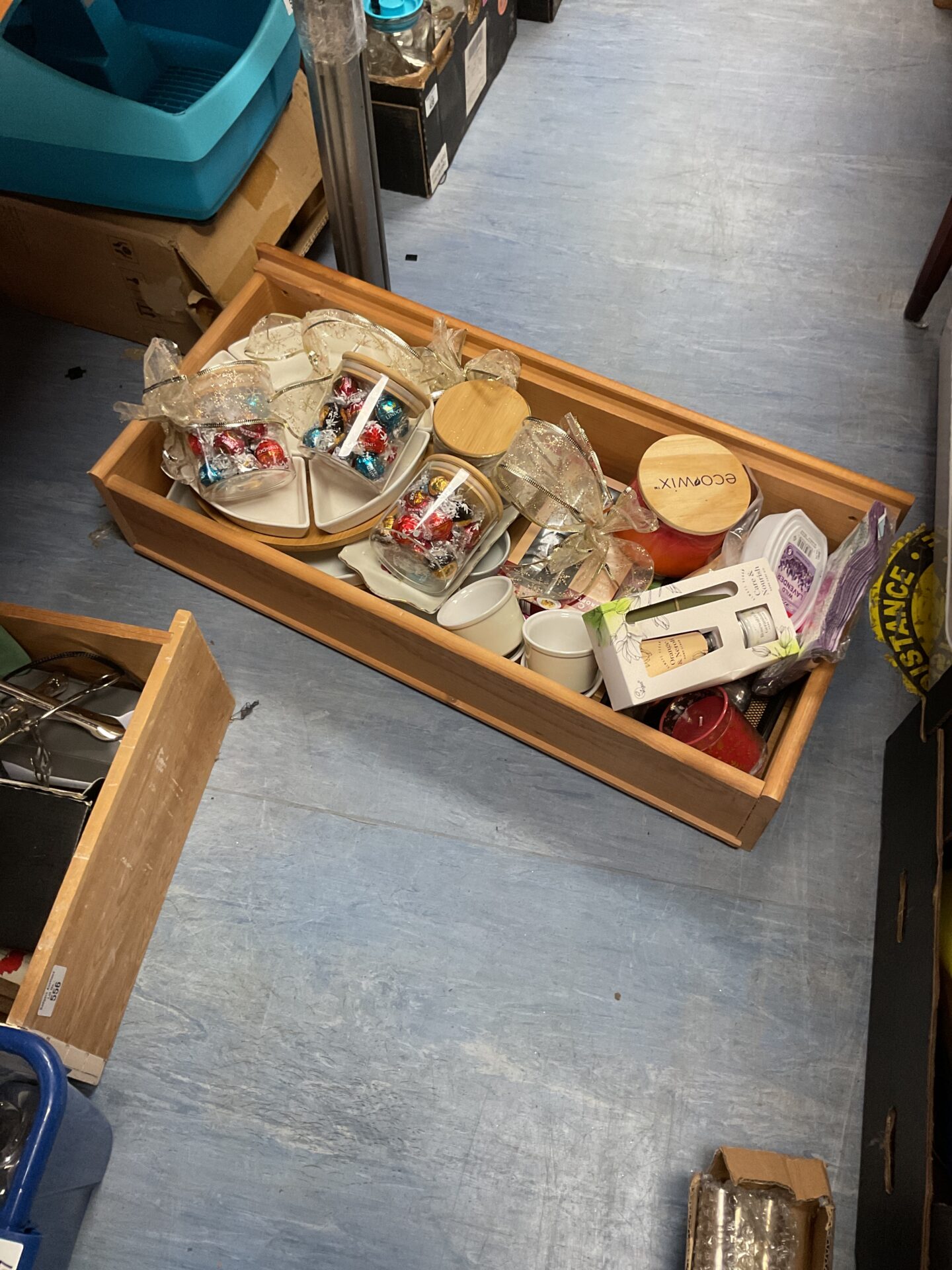 555 Wooden drawer of mixed items inc lindor chocolates, household items, candles and china